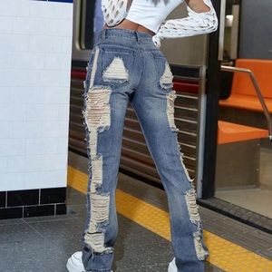 Fashion Nova jeans, stacked with lots of holes